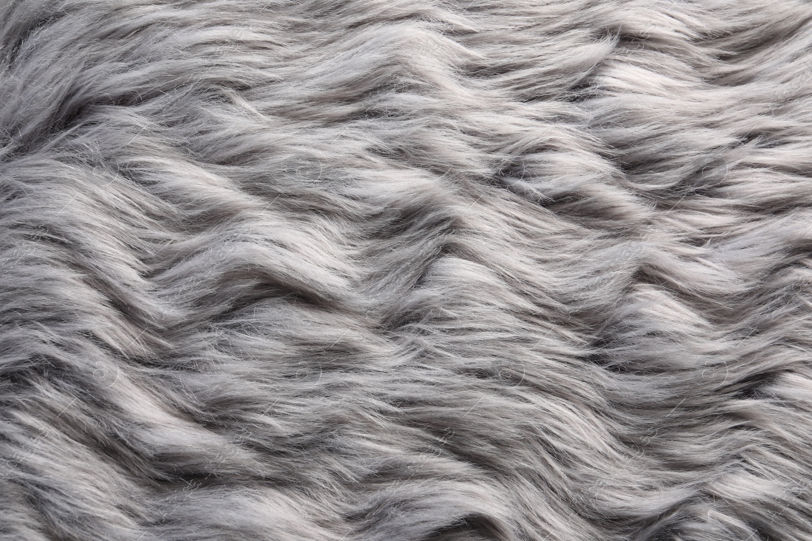 Photo of Texture of grey faux fur as background, closeup