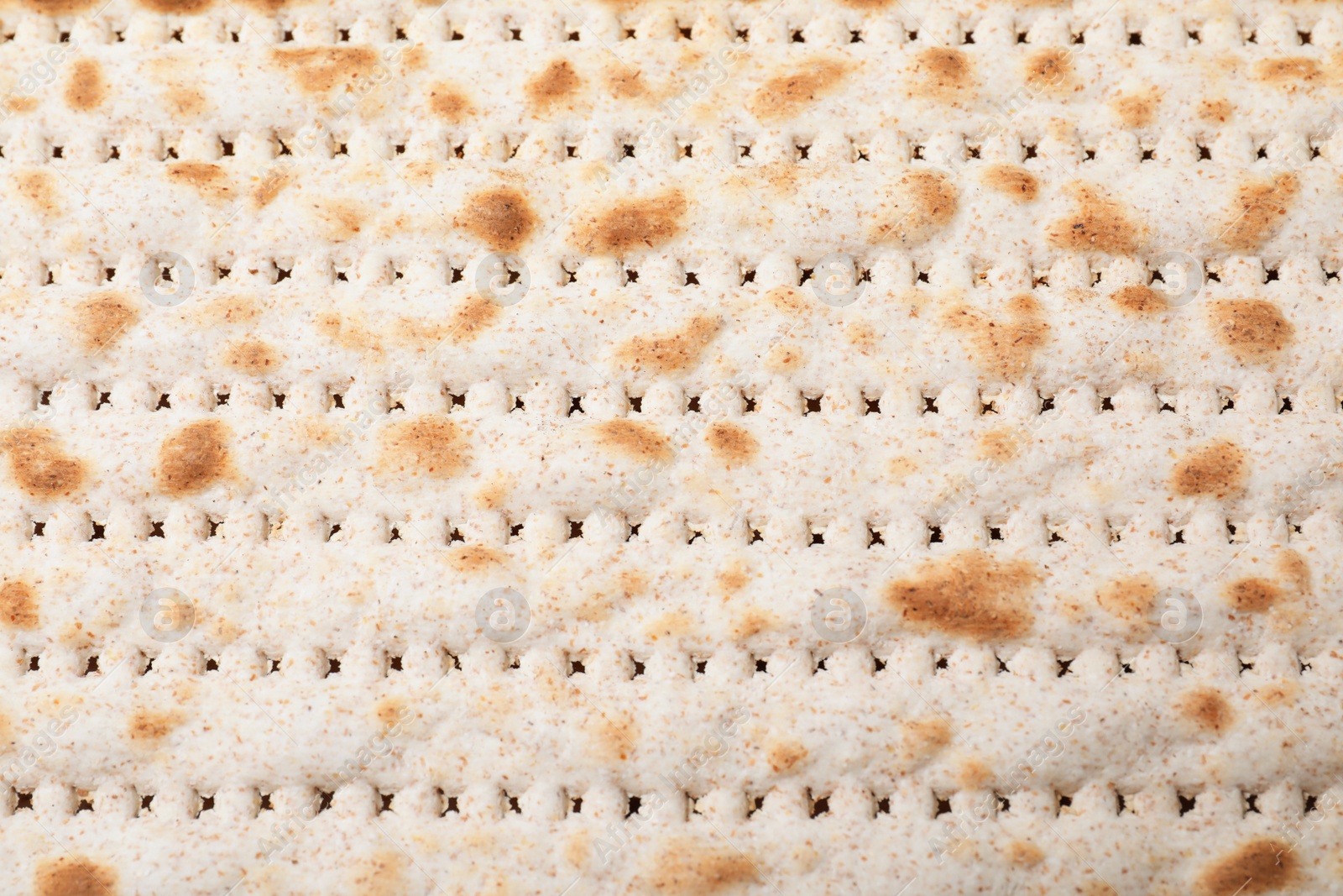 Photo of Traditional matzo as background, top view. Pesach celebration