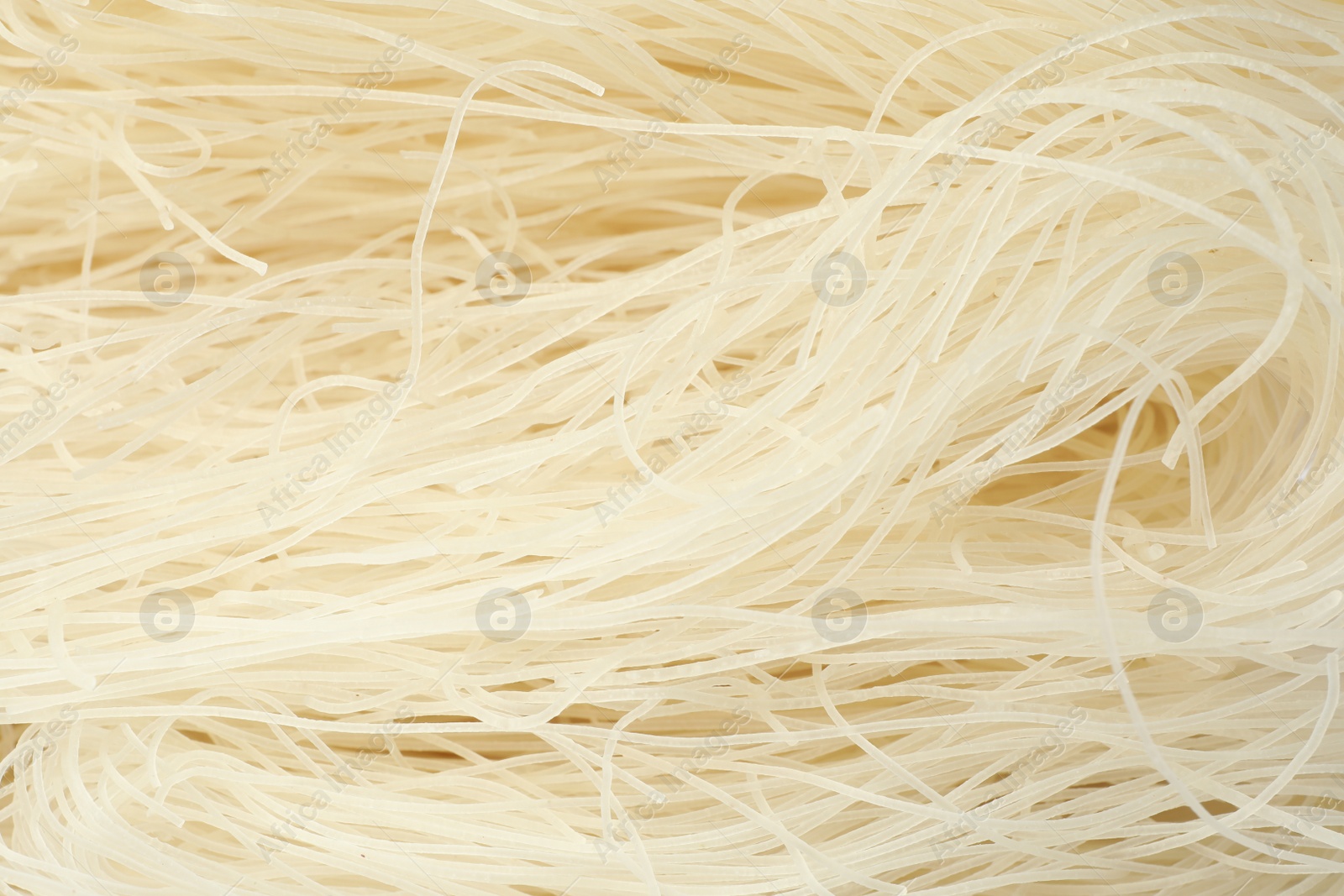 Photo of Raw rice noodles as background, closeup view