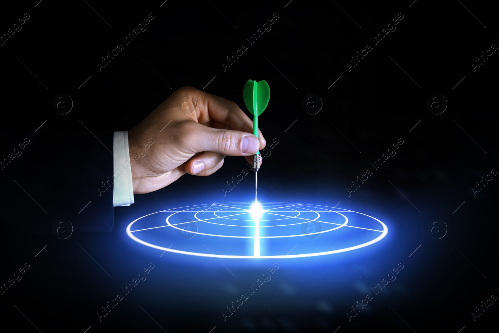 Image of Businessman aiming at digital target with dart against dark background, closeup