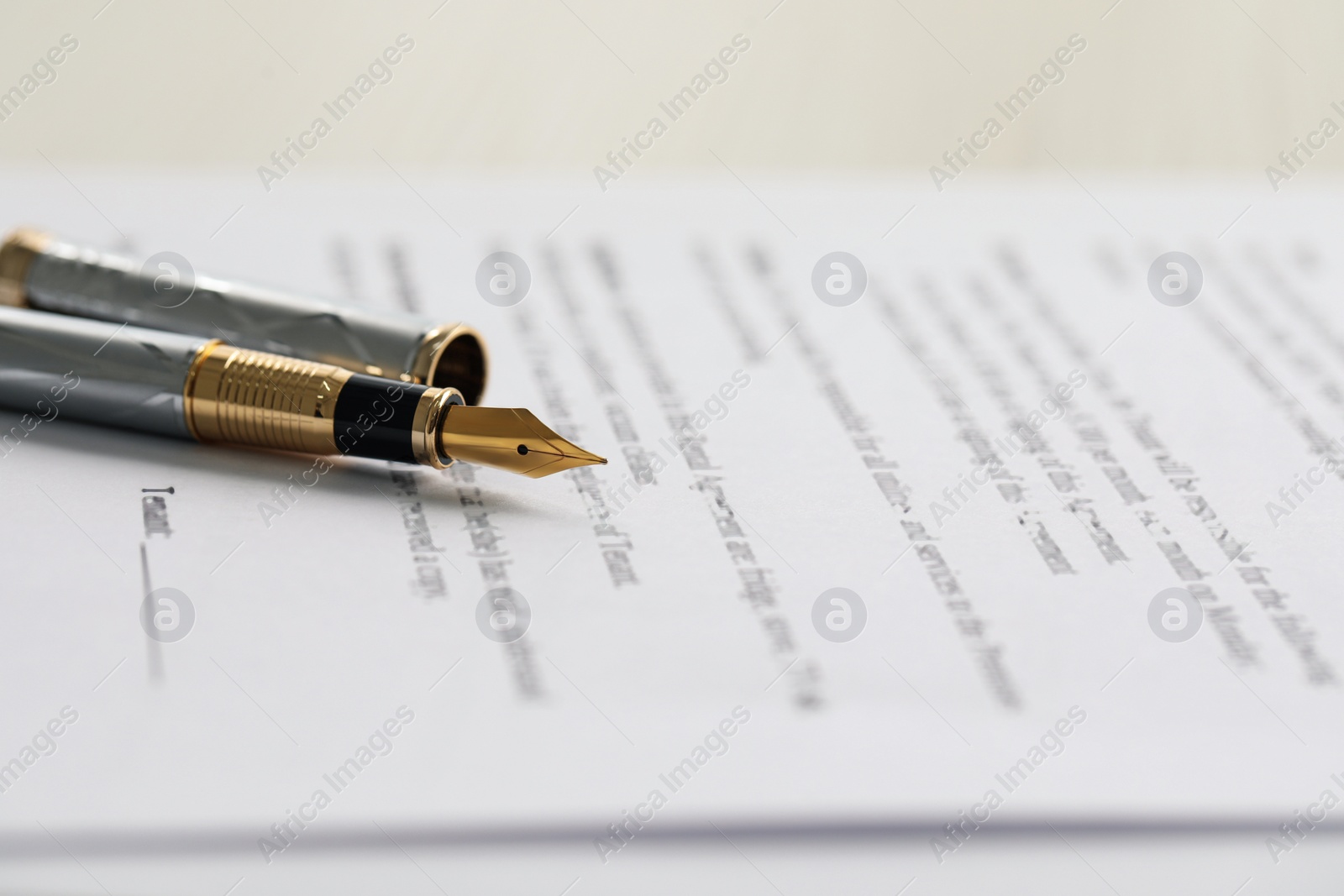 Photo of Fountain pen on paper document, closeup. Notary services