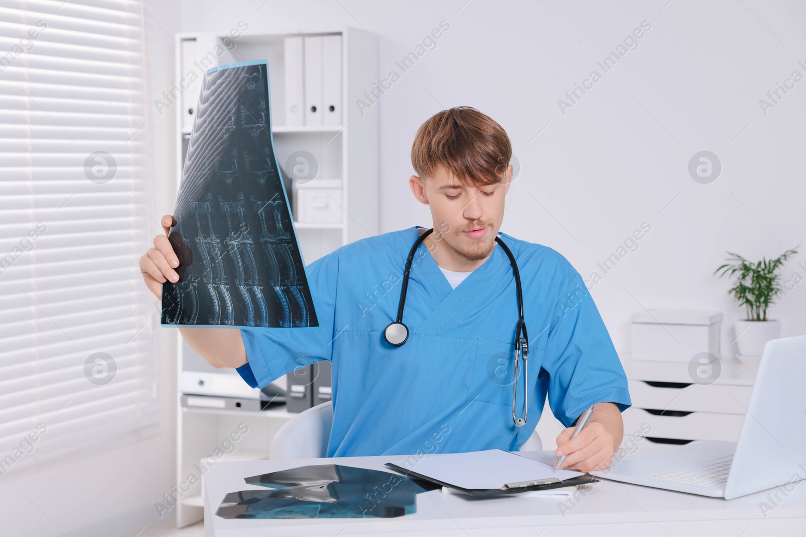 Photo of Doctor examining neck MRI image in clinic