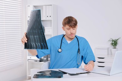 Doctor examining neck MRI image in clinic