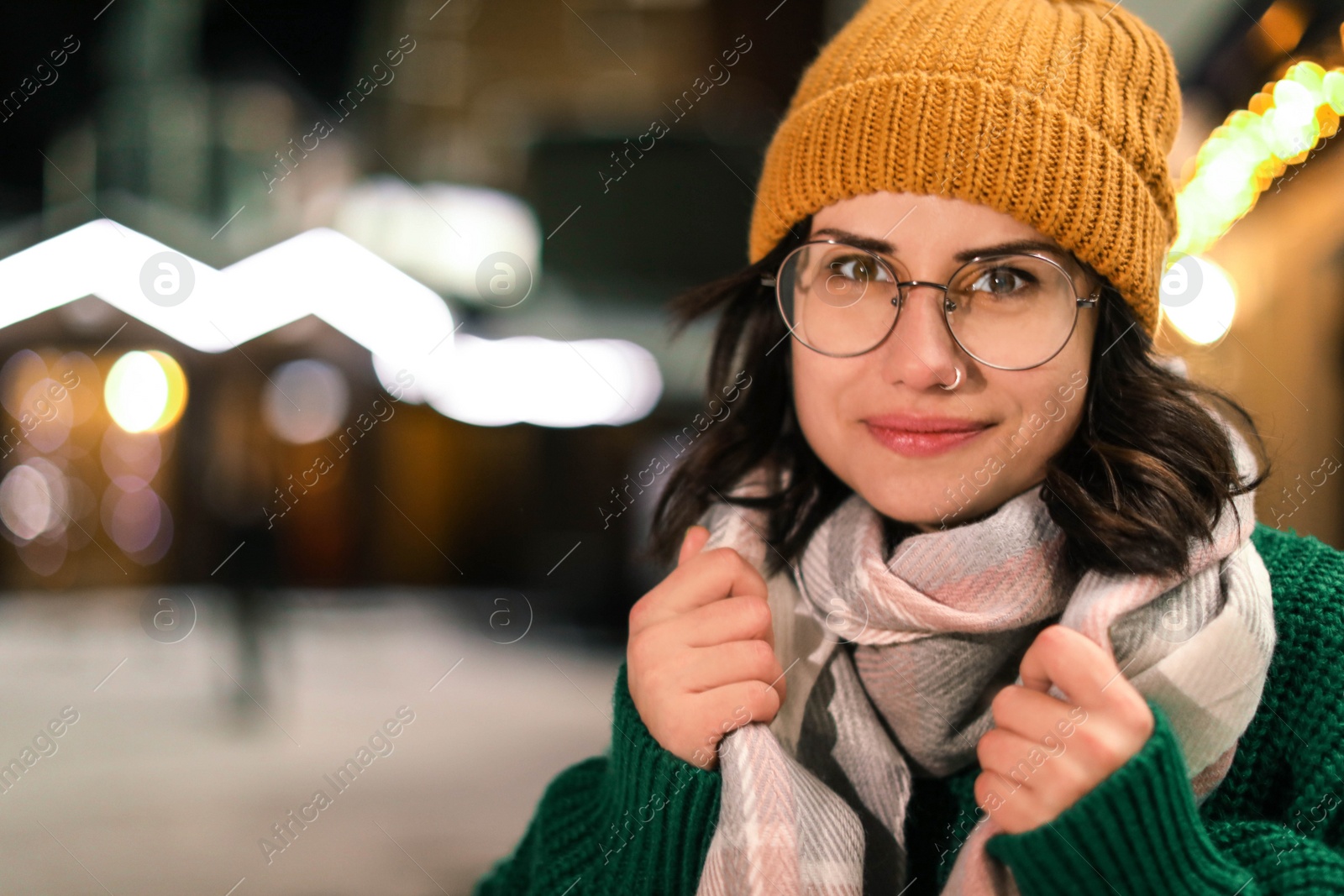 Photo of Portrait of young woman wearing warm clothes outdoors. Winter vacation