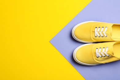 Photo of Bright stylish shoes on color background, top view. Space for text