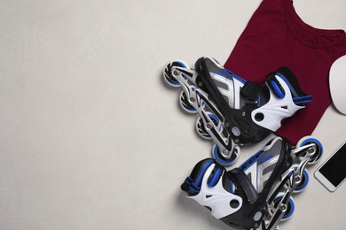 Photo of Flat lay composition with inline roller skates and space for text on light background