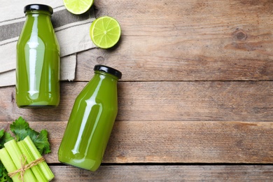 Photo of Bottles with celery juice and fresh ingredients on wooden table, flat lay. Space for text