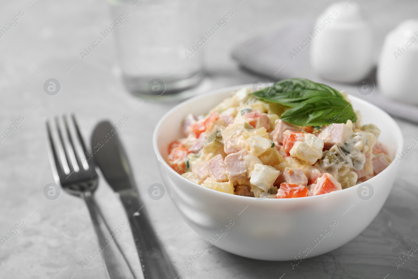 Photo of Delicious salad Olivier on light table, closeup