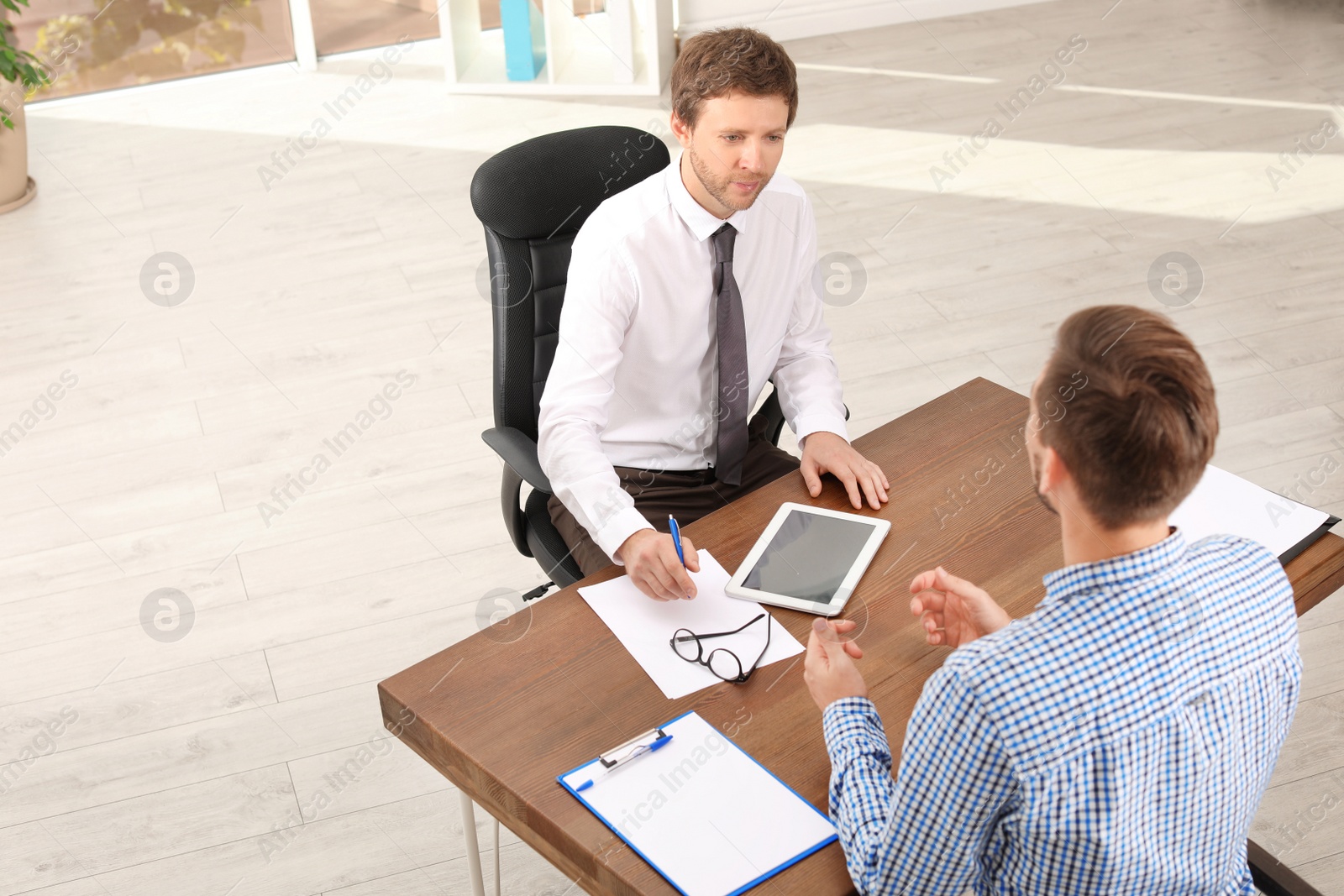 Photo of Human resources manager conducting job interview with applicant in office