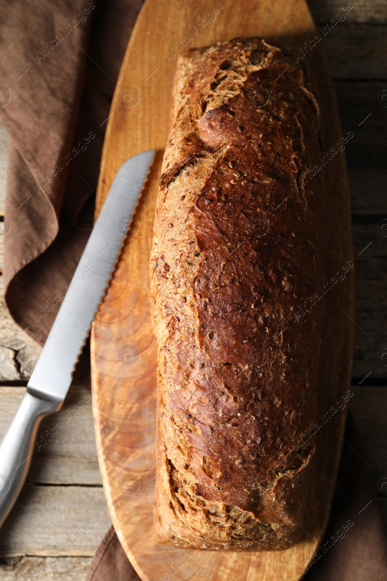 Photo of Freshly baked sourdough bread on wooden table, top view