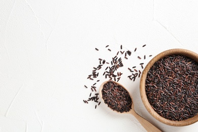 Photo of Flat lay composition with black rice and space for text on white background