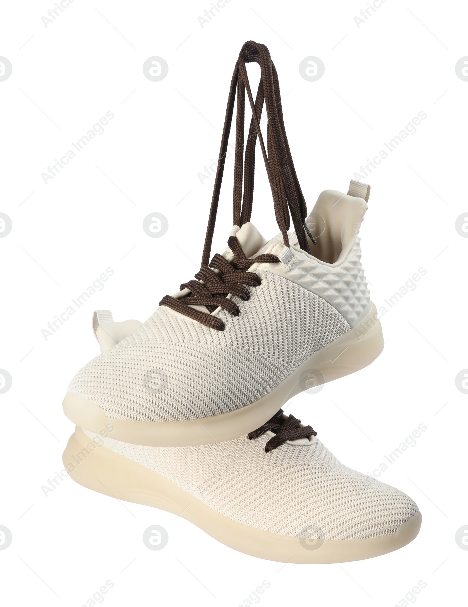 Photo of Pair of stylish shoes with laces hanging on white background