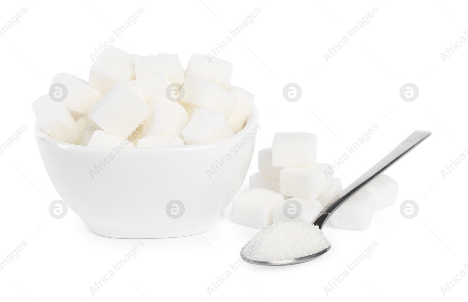 Photo of Ceramic bowl and spoon with refined sugar cubes on white background