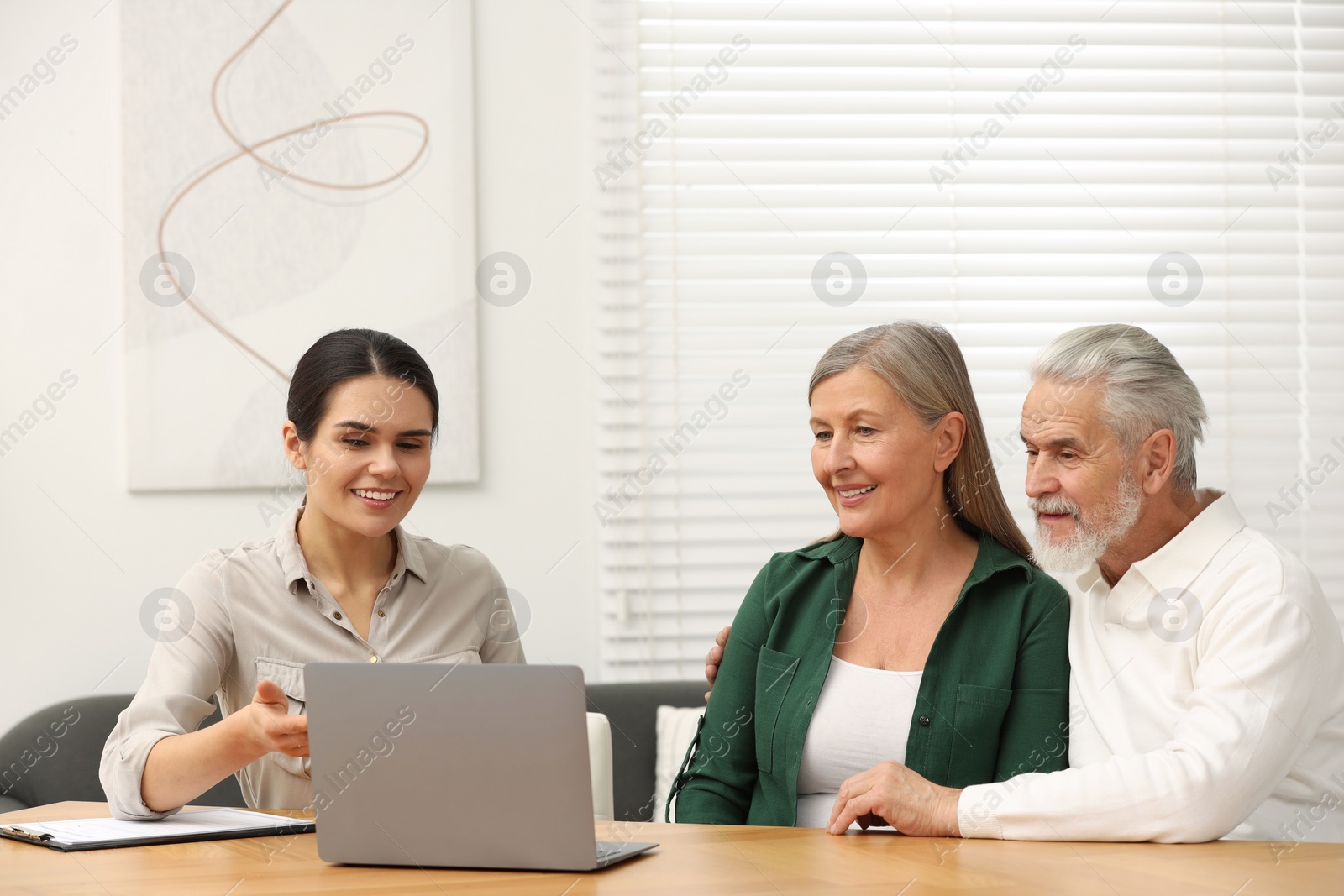 Photo of Notary consulting senior couple about Last Will and Testament in office