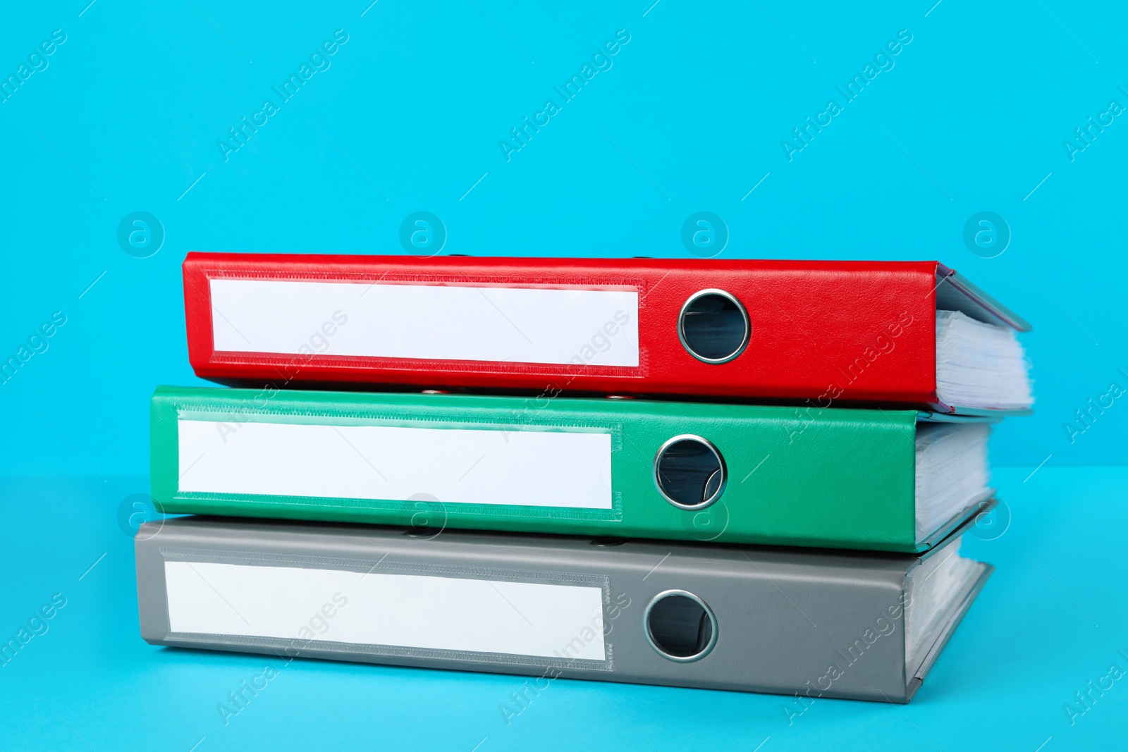 Photo of Stack of office folders on light blue background