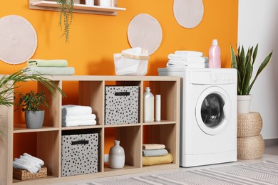 Stylish laundry room with washing machine. Interior design