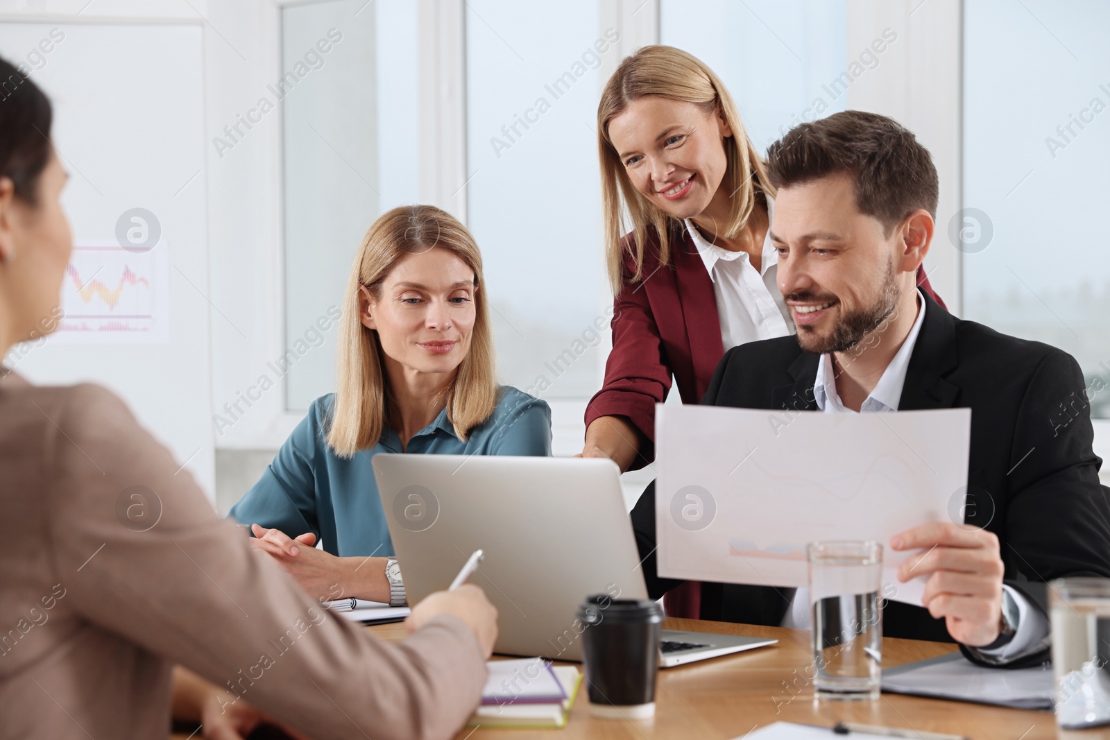 Photo of Businesswoman having meeting with her employees in office