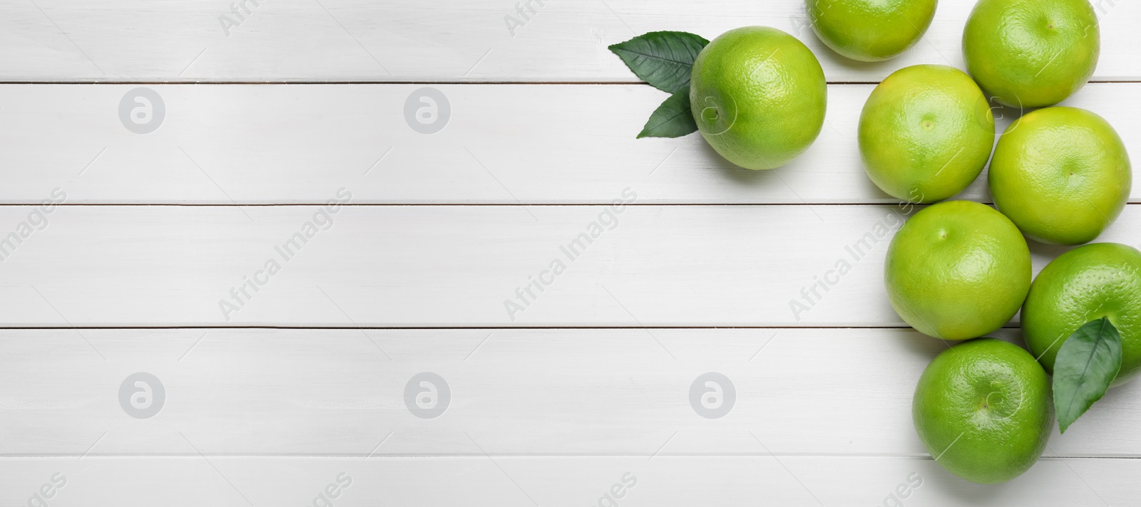 Photo of Fresh ripe sweeties on white wooden table, flat lay. Space for text