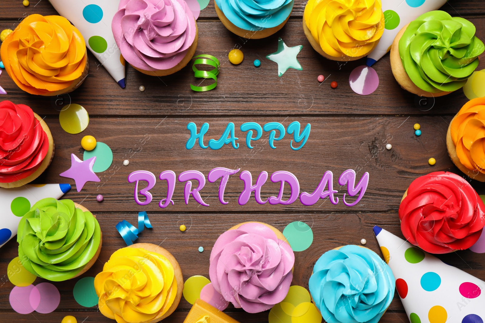 Image of Happy Birthday. Flat lay composition with colorful cupcakes on wooden background