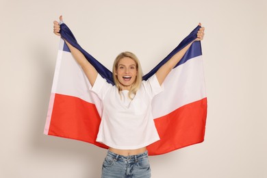 Emotional woman with flag of Netherlands on white background