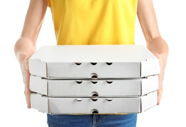 Woman holding cardboard pizza boxes on white background