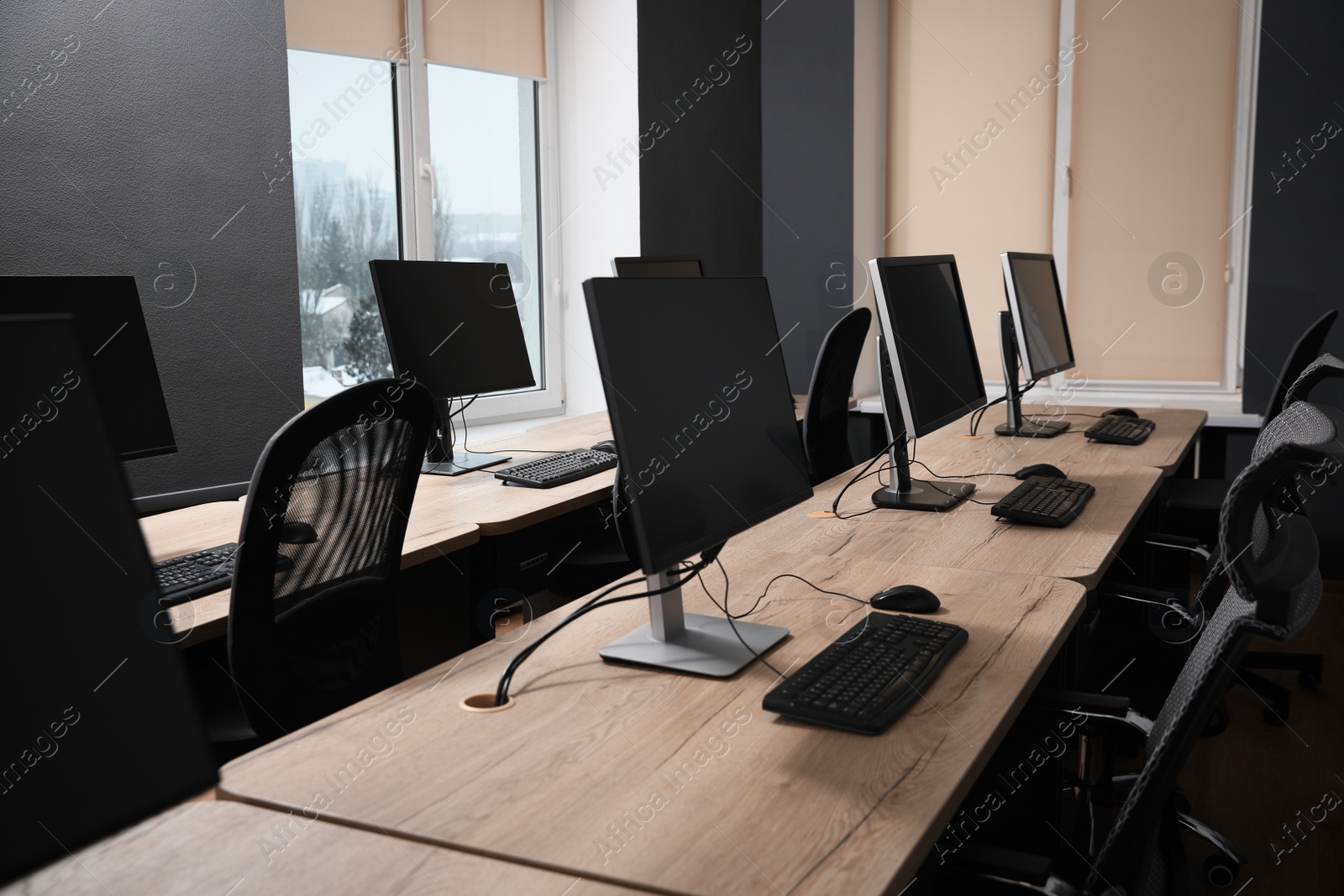 Photo of Many modern computers in open space office