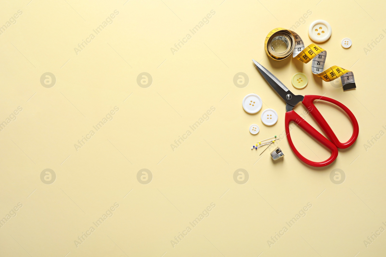 Photo of Flat lay composition with scissors on color background. Space for text