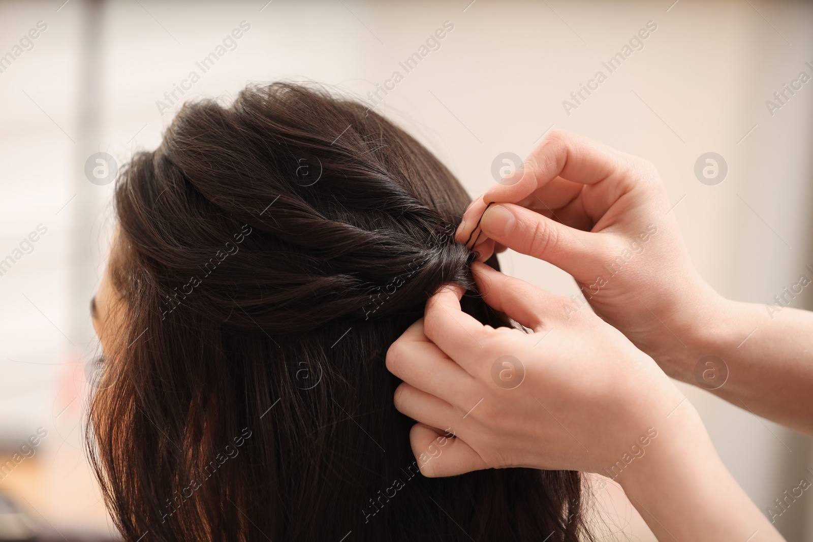 Photo of Hair styling. Professional hairdresser working with client indoors, closeup