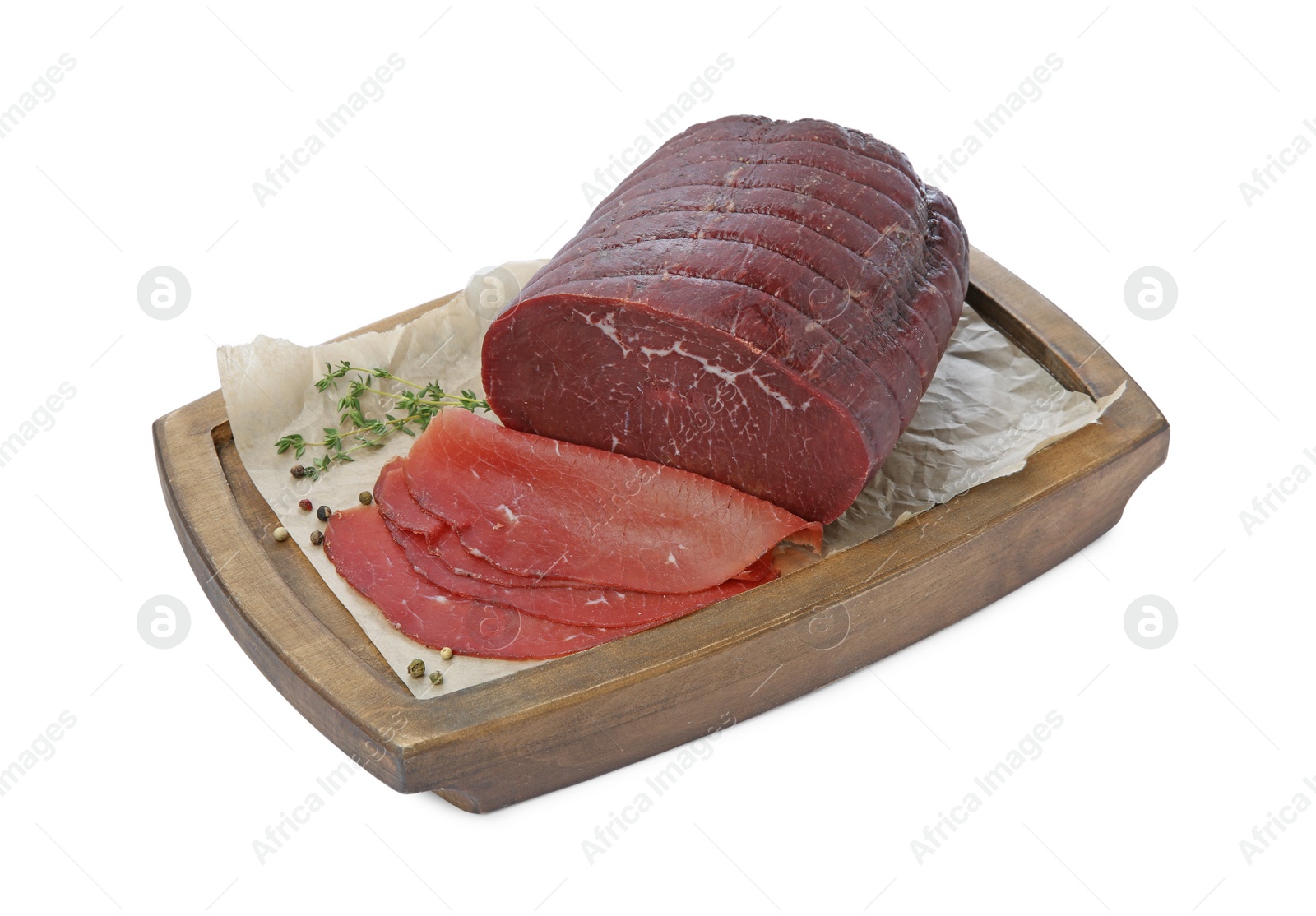 Photo of Tasty fresh dry bresaola, peppercorns and thyme isolated on white