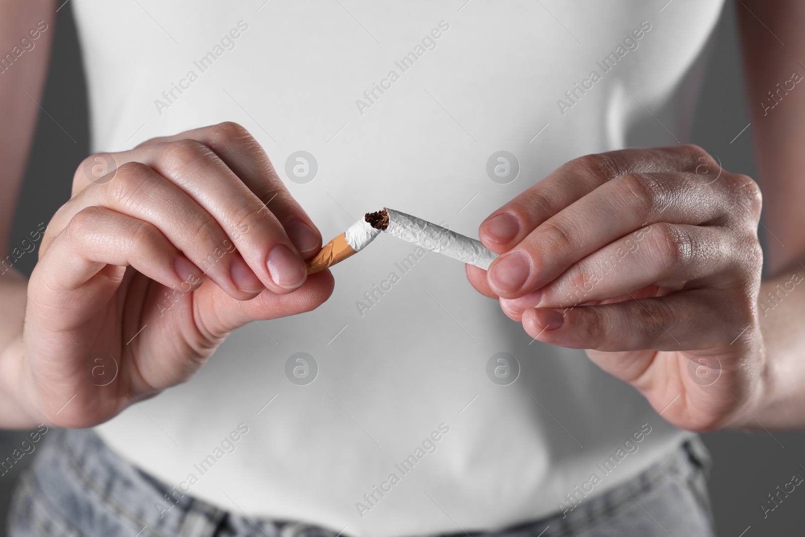 Photo of Stop smoking concept. Woman breaking cigarette, closeup