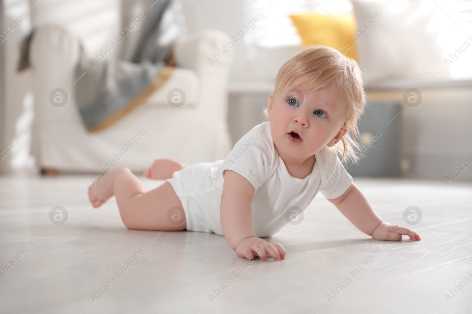 Photo of Cute little baby on floor at home