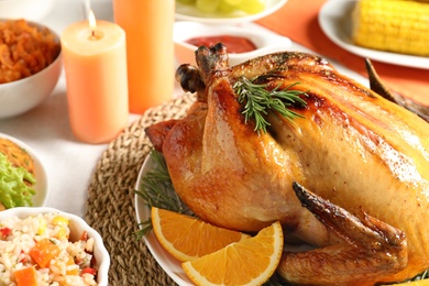 Photo of Delicious roasted turkey with garnish on dinner table