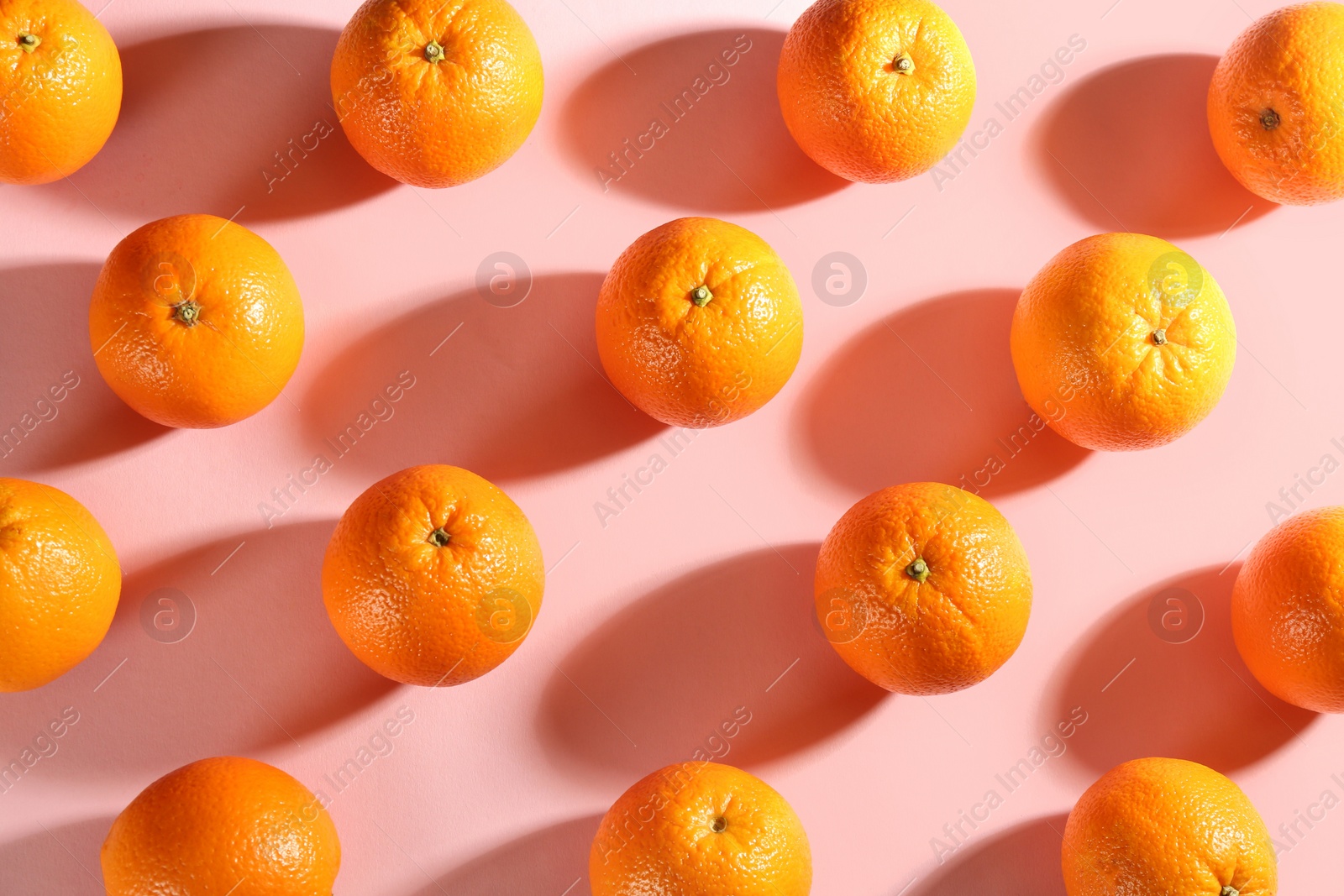 Photo of Whole fresh ripe oranges on pink background, flat lay
