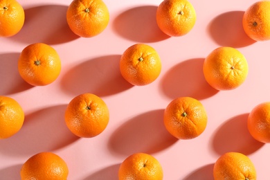 Photo of Whole fresh ripe oranges on pink background, flat lay