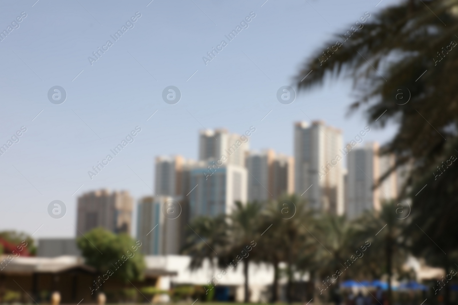 Photo of AJMAN, UNITED ARAB EMIRATES - NOVEMBER 04, 2018: Landscape with modern high buildings on sunny day, blurred view