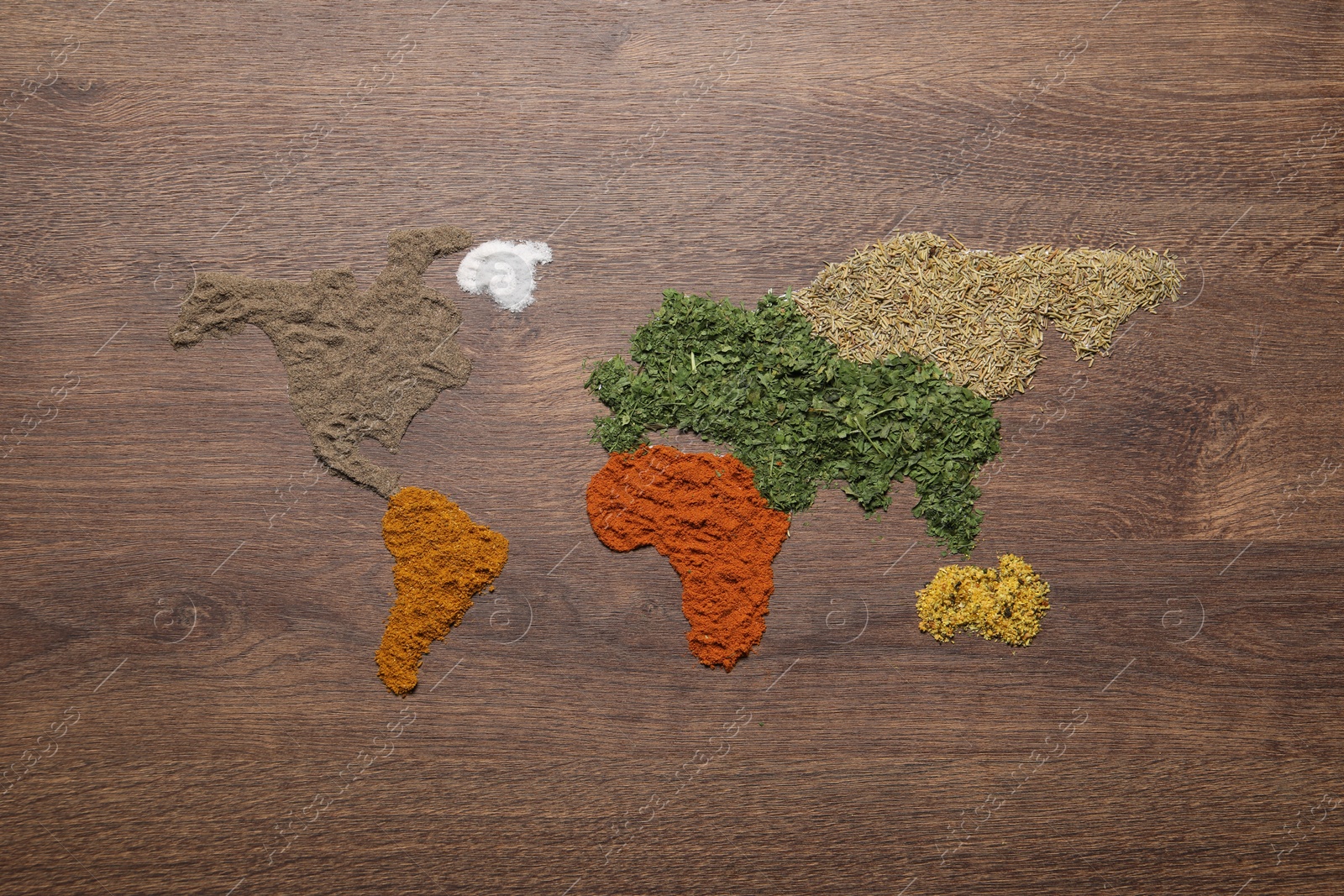 Photo of World map of different spices on wooden table, flat lay