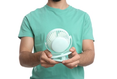 Man with portable fan on white background, closeup. Summer heat