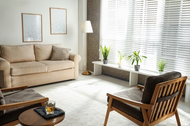 Photo of Living room interior with comfortable sofa and armchairs