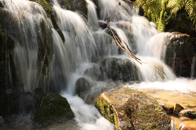 Picturesque view of mountain waterfall on sunny day