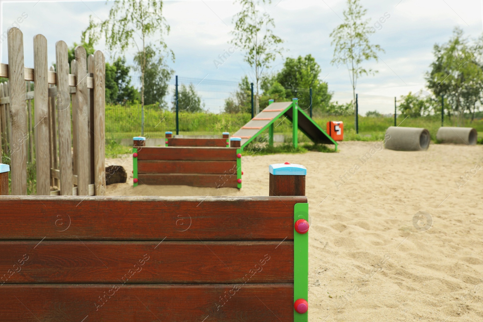 Photo of Wooden rover jump over, king of hill and doggie crawls on animal training area outdoors