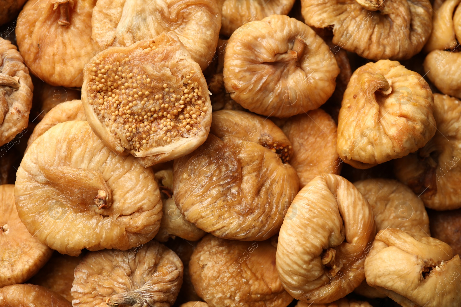 Photo of Many tasty dried figs as background, top view