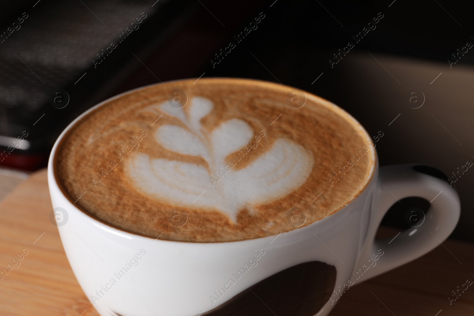 Photo of Cup of fresh aromatic coffee on table in cafe, closeup