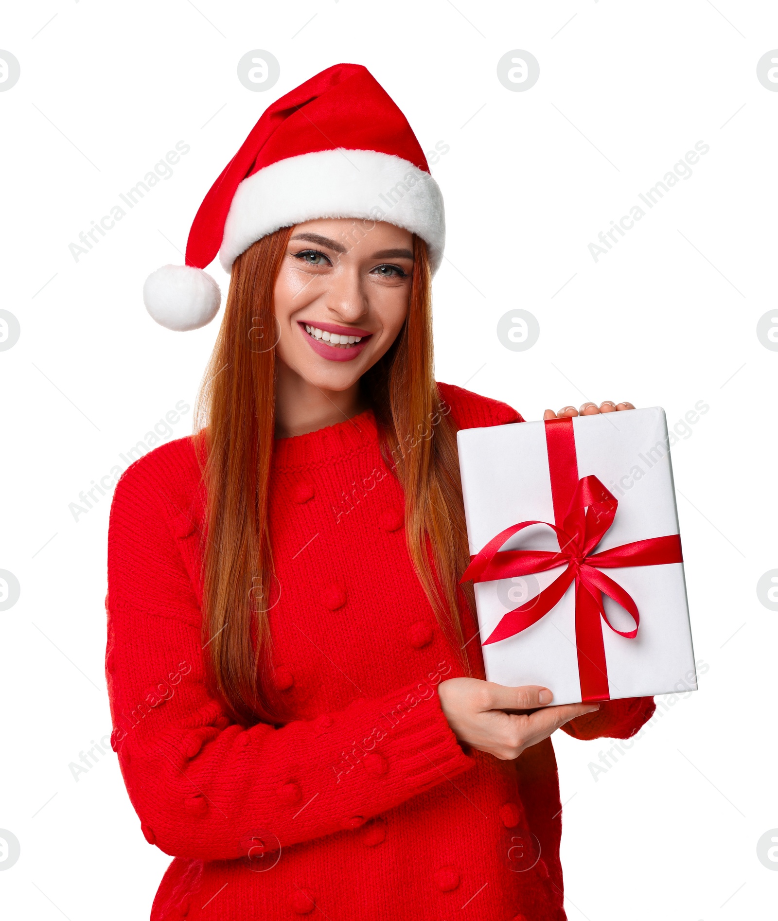 Photo of Young woman in red sweater and Santa hat with Christmas gift on white background