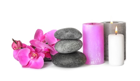 Composition with spa stones and candles on white background