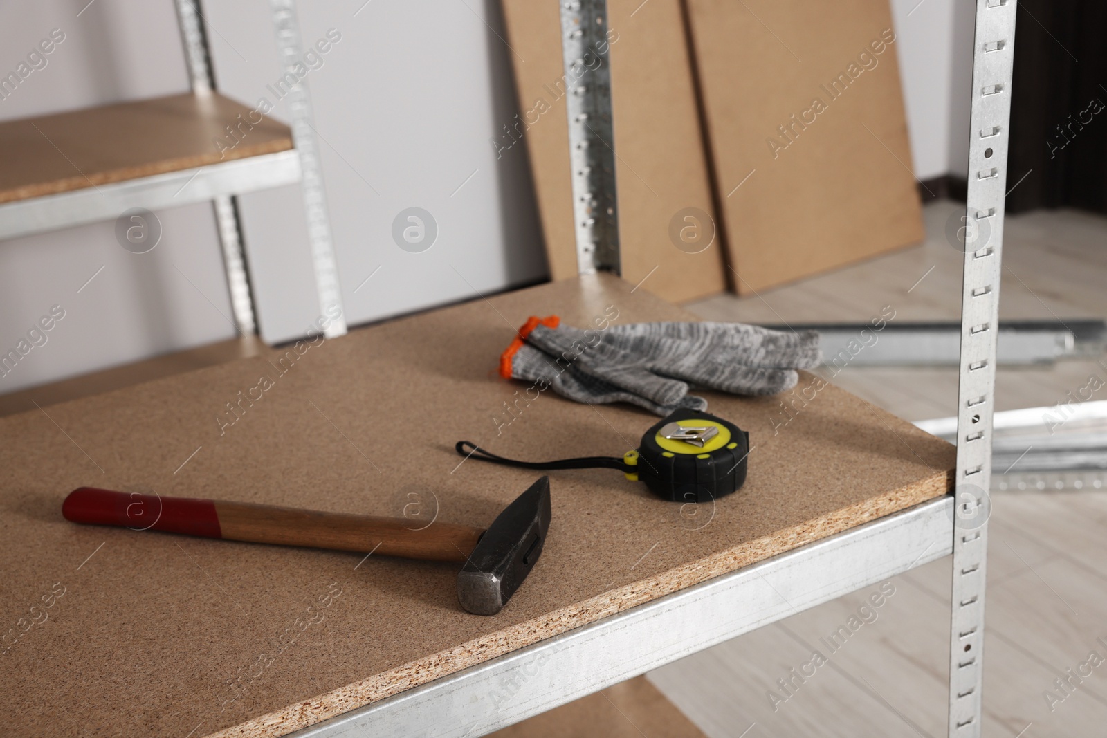 Photo of Metal storage shelf with room renovation tools in office