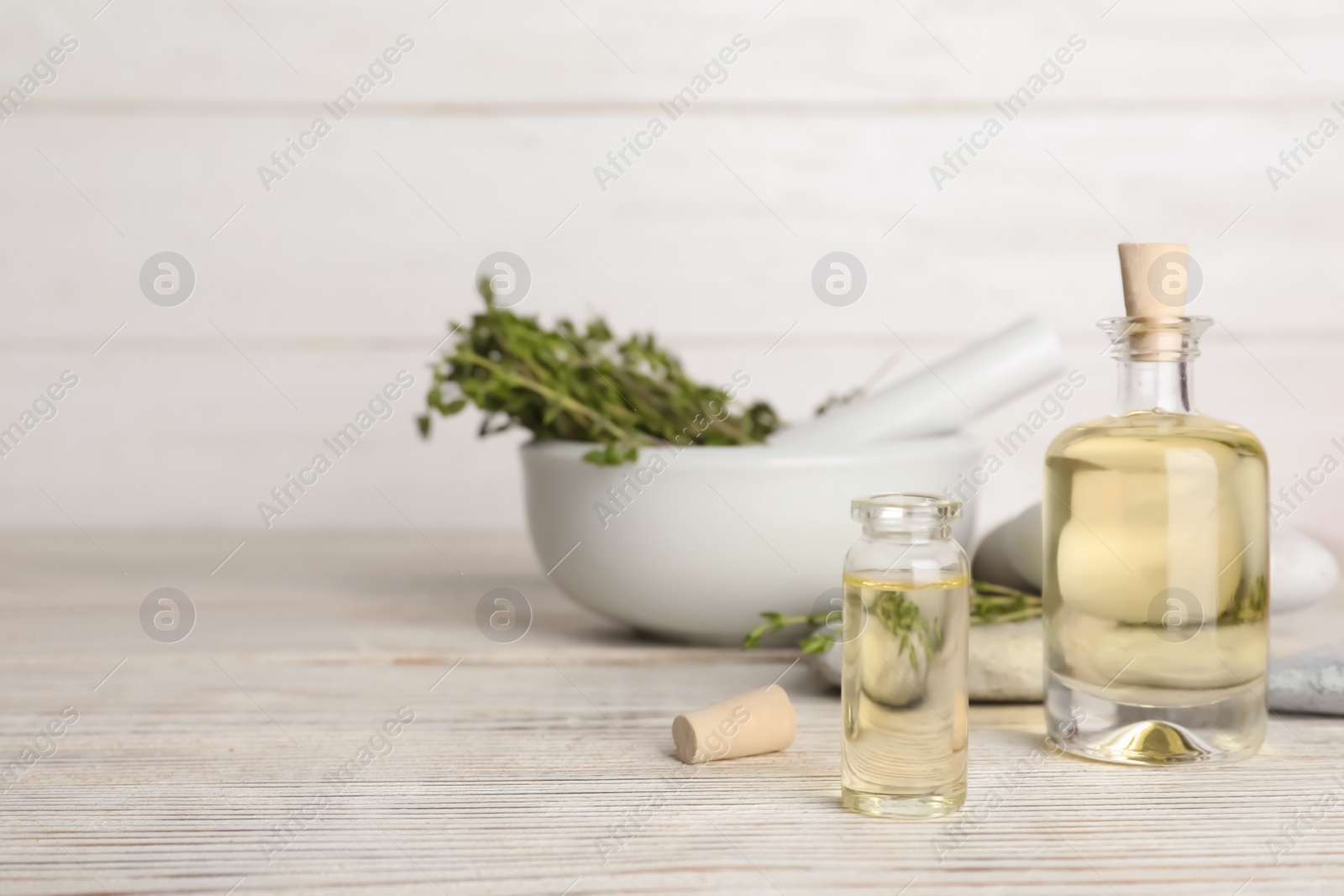 Photo of Composition with herbal essential oil on table. Space for text