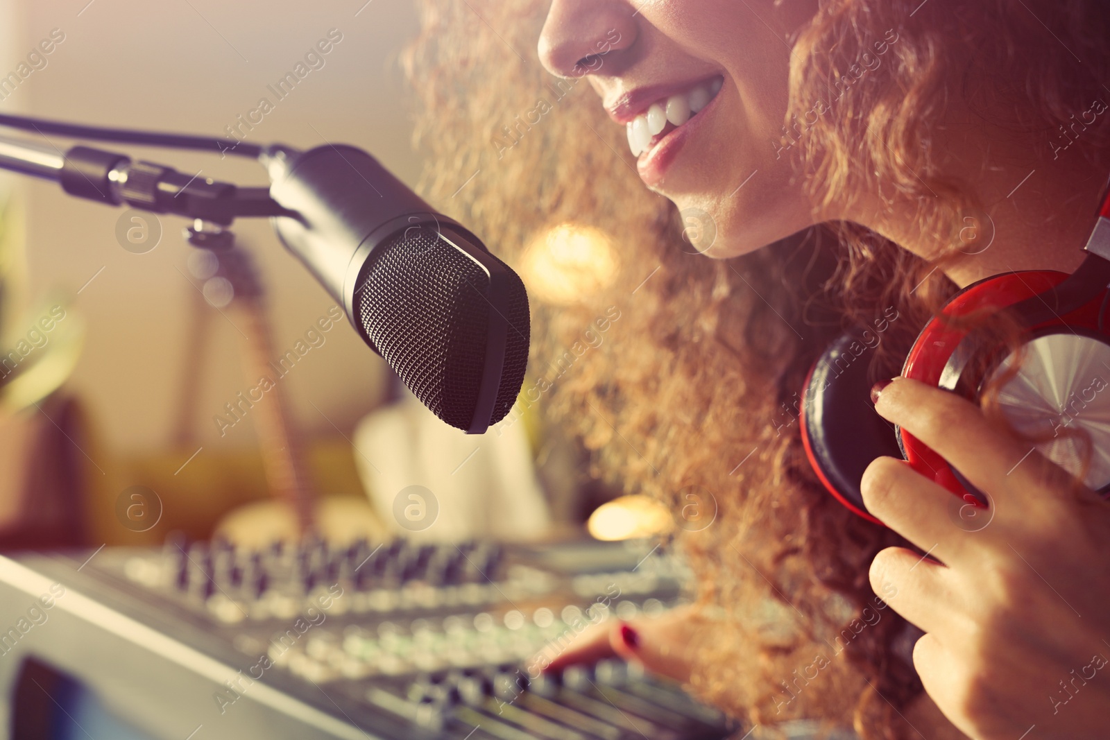 Photo of African American woman working as radio host in modern studio, closeup