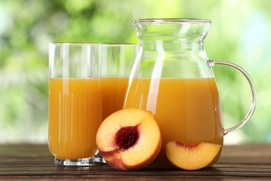 Photo of Tasty peach juice and fresh fruit on wooden table outdoors, closeup
