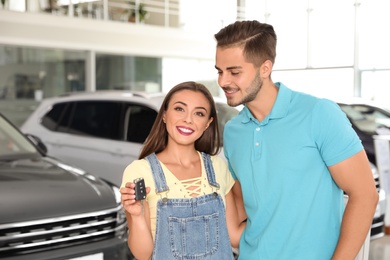 Photo of Happy couple with car key in salon
