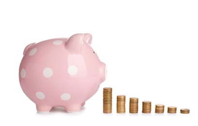 Photo of Piggy bank and different height coin stacks on white background. Space for text